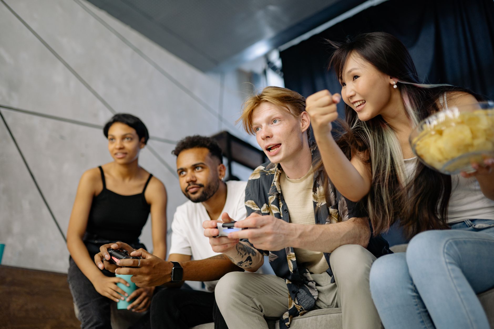 Four friends gaming enthusiastically inside a modern home, enjoying a lively moment. — An Introduction to the Benefits of a R