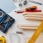 A top view of various woodworking tools and materials on a white table. — Asbestos Survey Best Practices: Ensuring Safety and