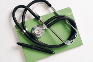 Top view of a stethoscope and pen on a green notepad, ideal for medical and educational themes. — CBD Oil And Diabetes