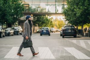 Sikh businessman with a turban crossing a city street on a zebra crossing, carrying a briefcase. — Connecting with Collectors