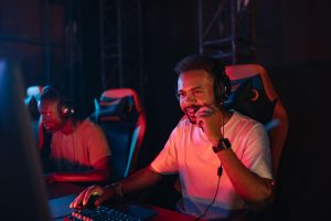 Two gamers immersed in an esports tournament, focused with headsets and keyboards. — Elevating Your Chances: Decoding Lsm99 C