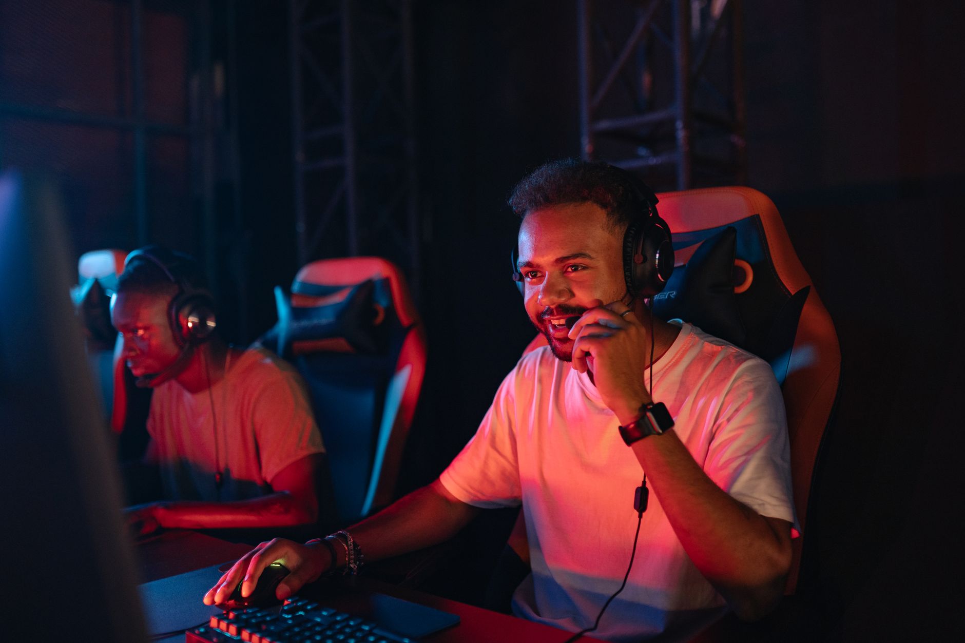 Two gamers immersed in an esports tournament, focused with headsets and keyboards. — Elevating Your Chances: Decoding Lsm99 C