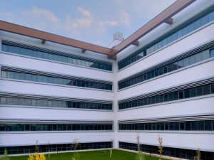 Contemporary office building featuring sleek glass windows and minimalist design. — Finding A Website For Medicare Advantage