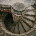 Top view of a spiraling stone staircase outdoors, showcasing architectural beauty. — Hello world!