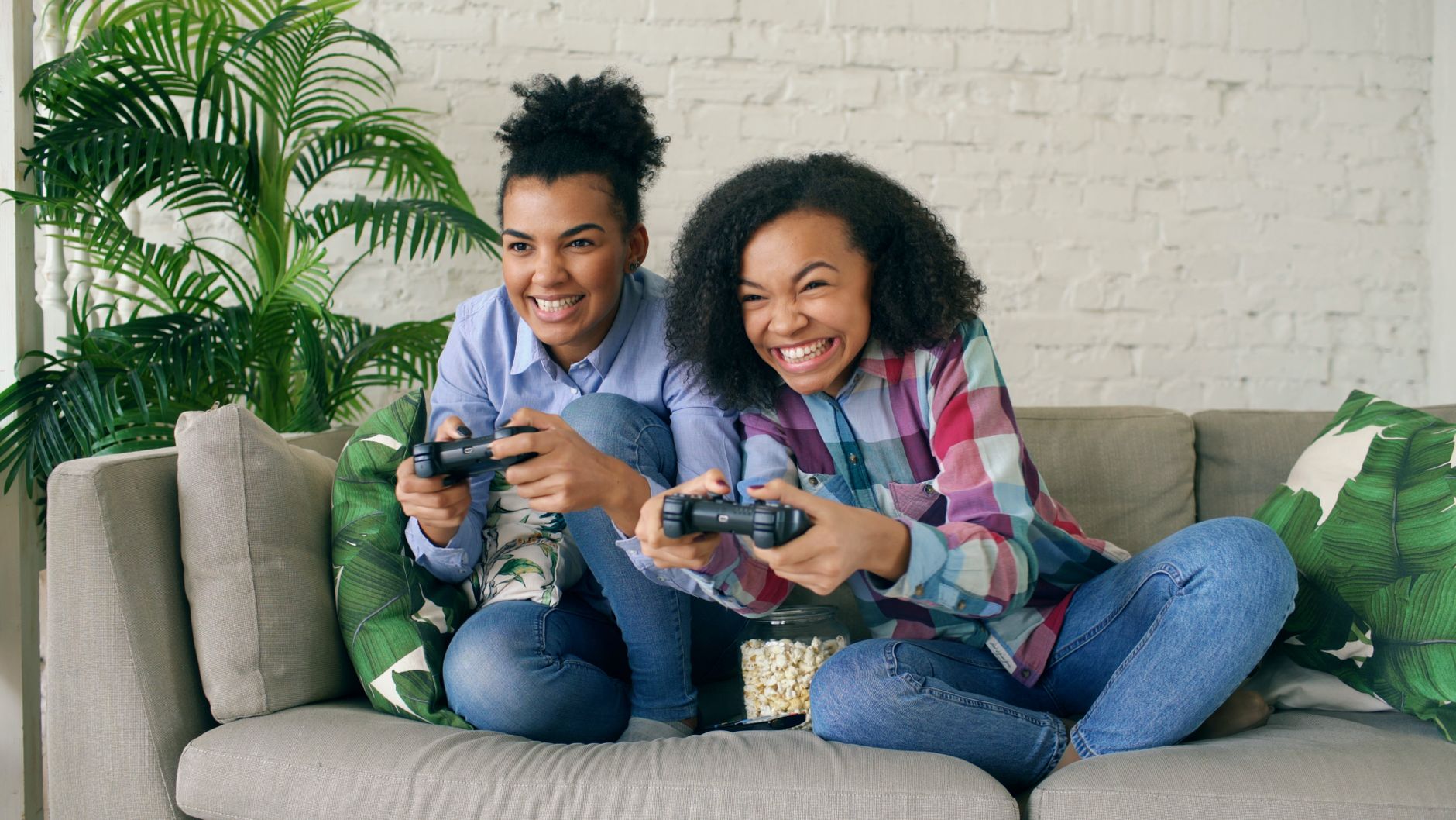 Two teenagers enjoying video games on a couch, showing excitement and joy. — How to Tailor Dana Slots to Your Betting Style