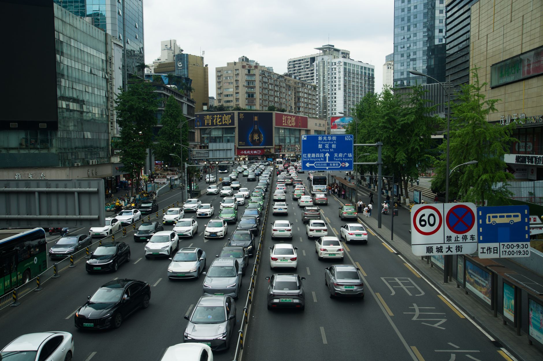 Heavy traffic on a busy Shanghai street lined with skyscrapers and billboards during the day. — How White label SEO Nurtures