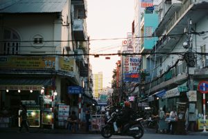 Colorful busy street scene in Cần Thơ, Vietnam with vibrant signs and people. — Introduction to Audio Mastering