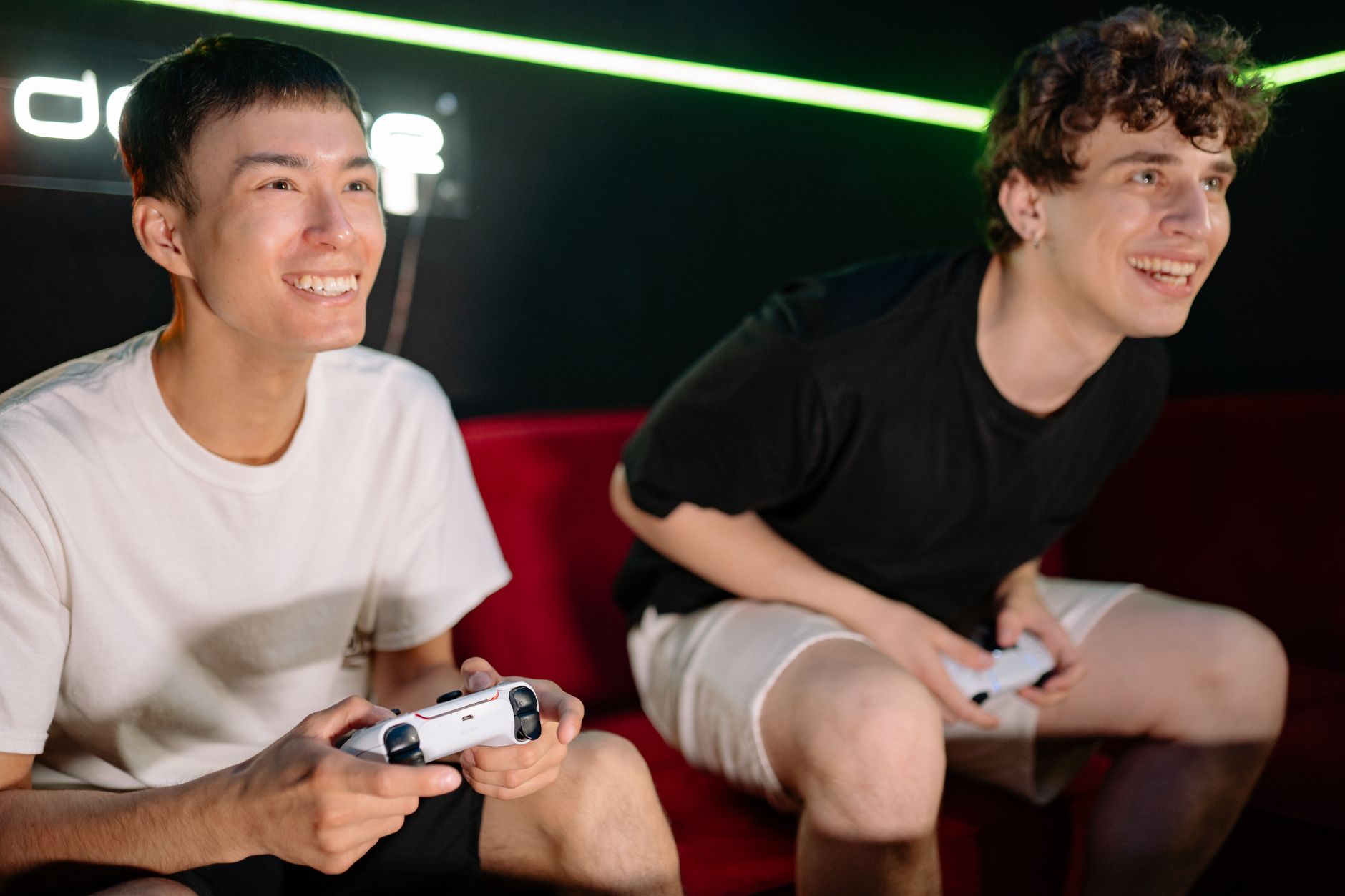 Two friends having fun playing video games indoors, captured in a lively and engaging moment. — Online Slots: The Ultimate Be
