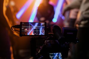 Capturing a vibrant live concert scene with dynamic lighting using professional video equipment. — Score a Touchdown with You