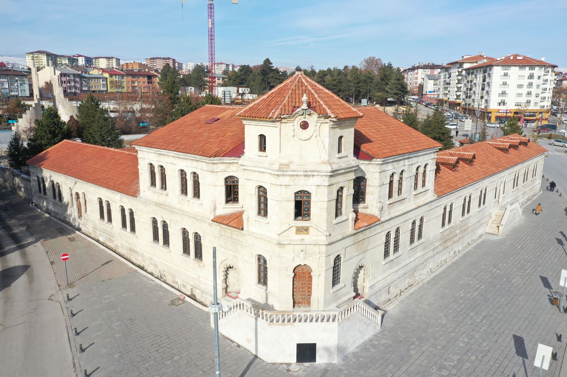 Aerial view of a historic stone building with red tile roofs in Sivas, Turkey, on a sunny day. — Steps to Add Image to PDF