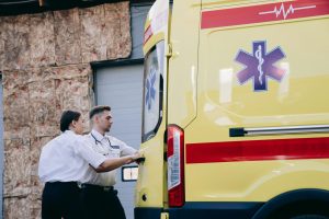 Two paramedics close the rear doors of an ambulance, preparing for emergency response. — Tend To Be More Seniors Individuals