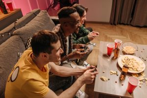 Group of friends playing video games and enjoying snacks indoors. — The Best Way To pg slot?