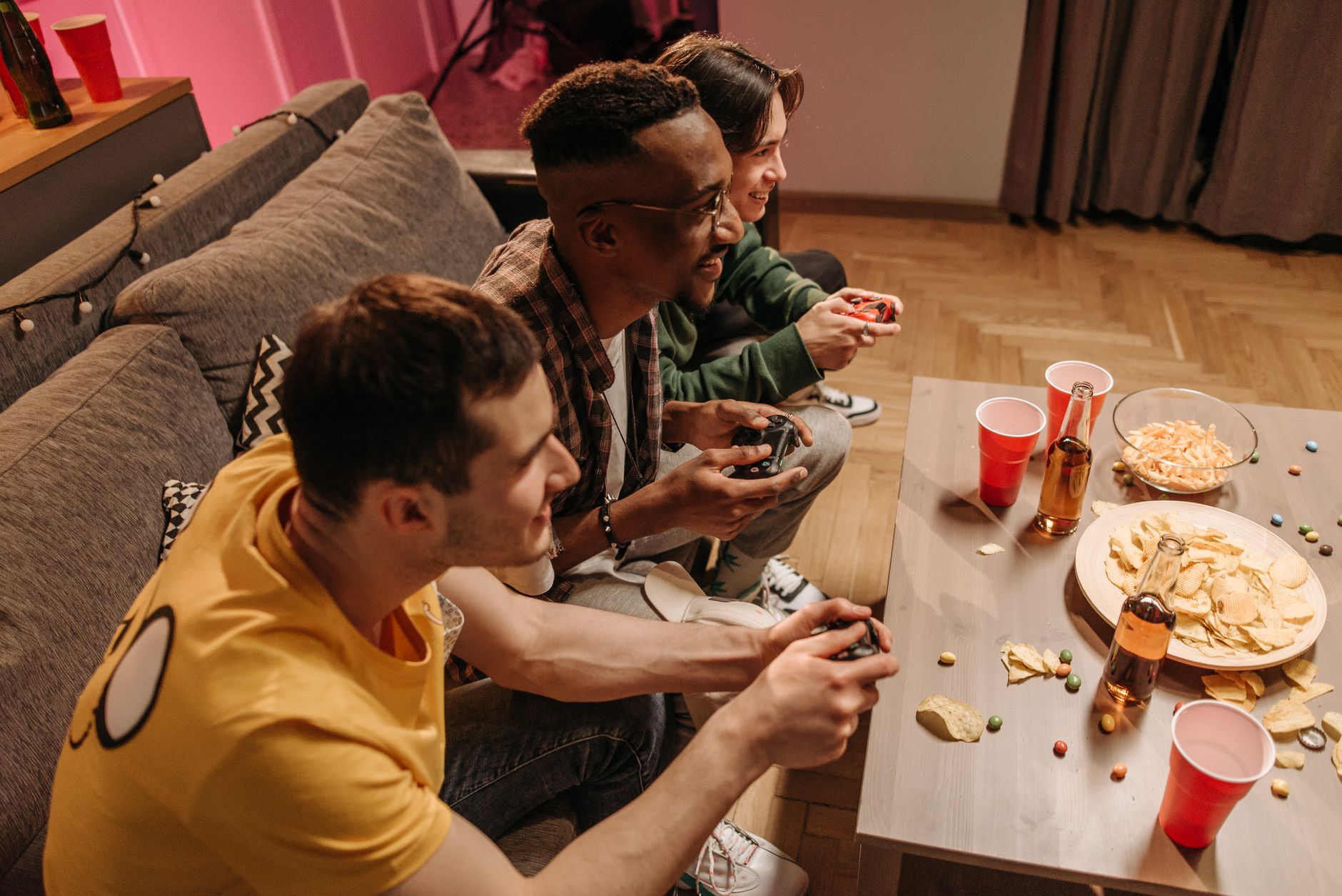 Group of friends playing video games and enjoying snacks indoors. — The Best Way To pg slot?