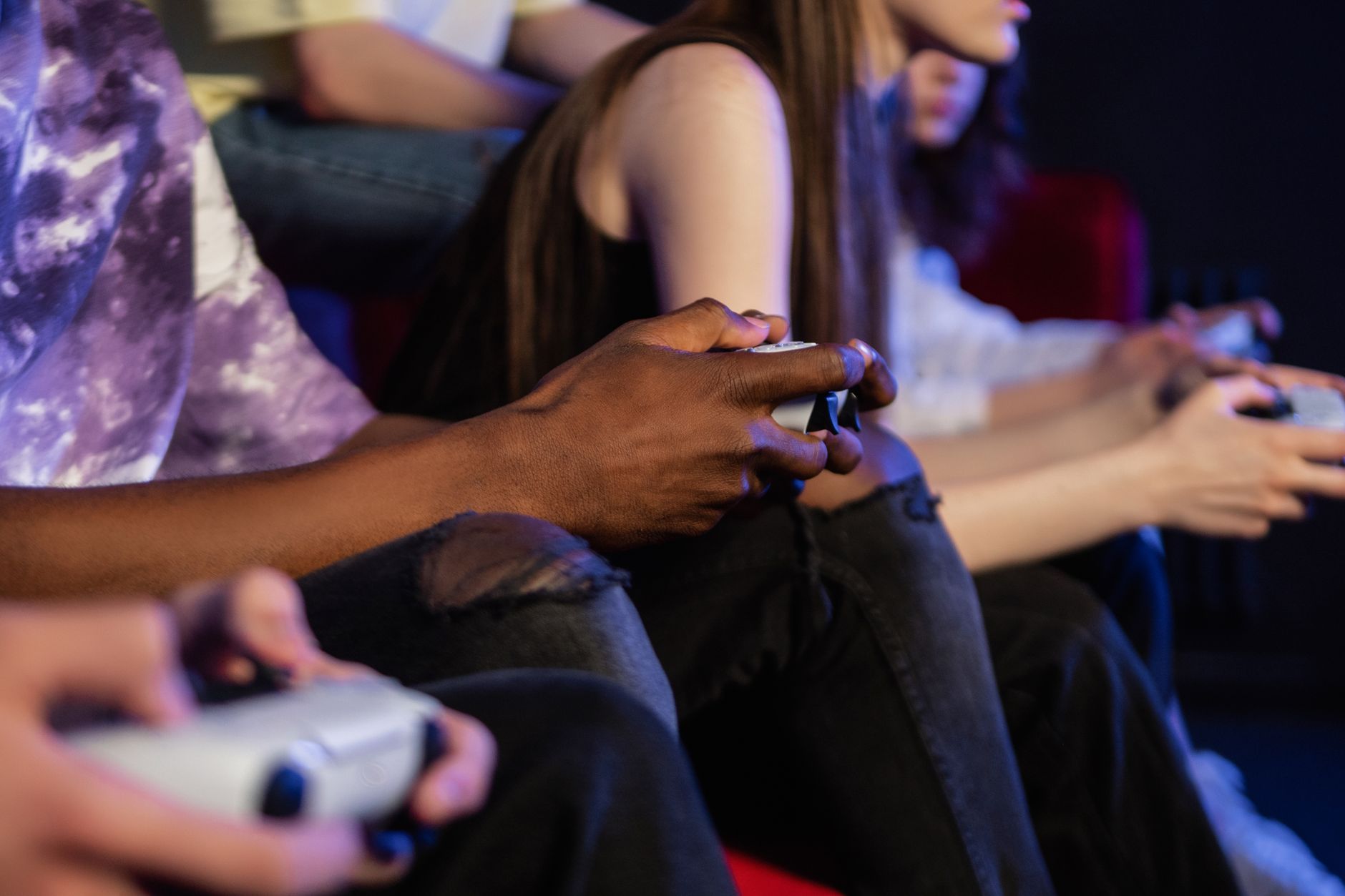 Teens playing video games with controllers, focused and engaged. — The Primary Real Life Benefits Which Can Be Attained Throu