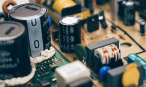 Detailed close-up of capacitors and components on a circuit board, showcasing electronic technology. — The Role of Lottie Ani
