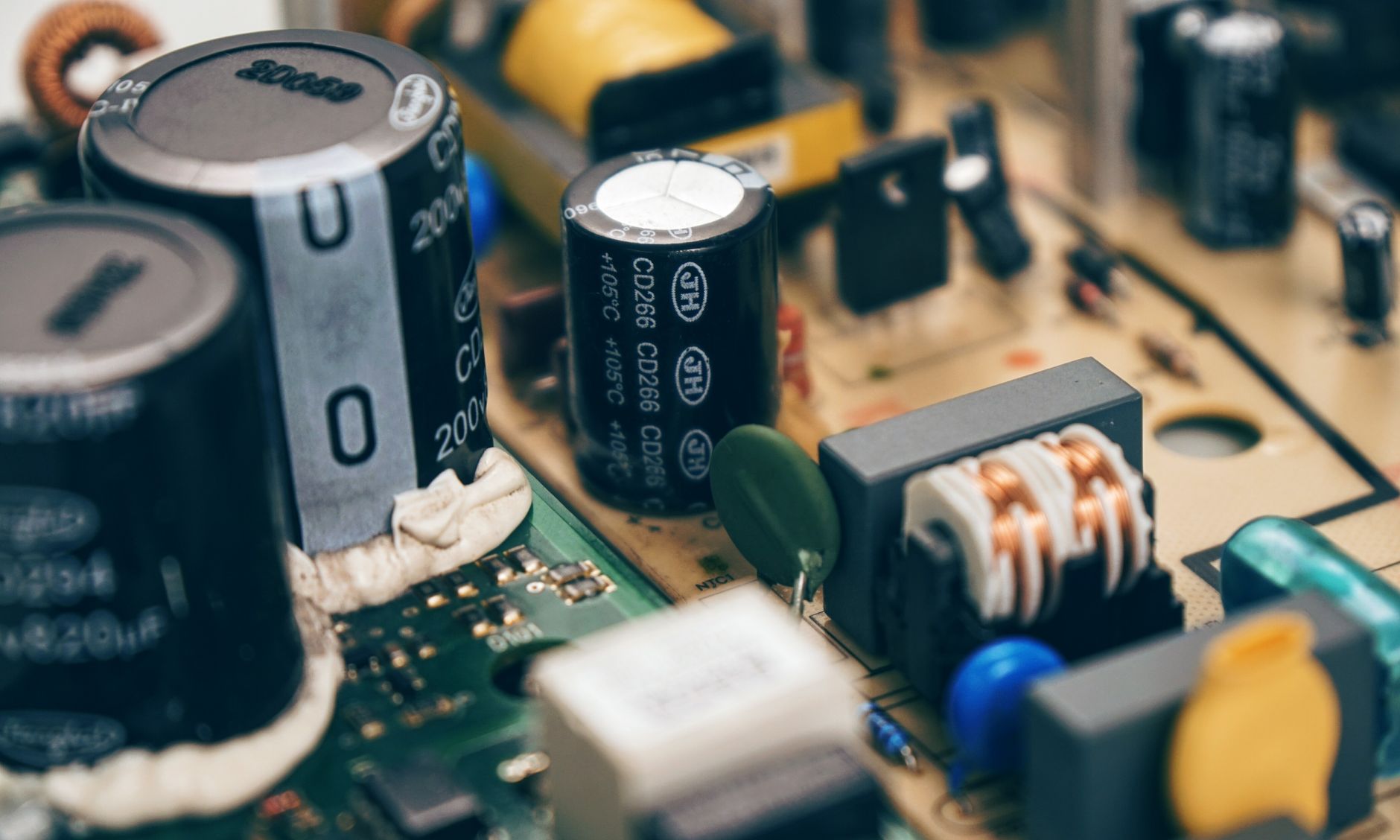 Detailed close-up of capacitors and components on a circuit board, showcasing electronic technology. — The Role of Lottie Ani