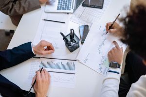 Business team analyzing financial charts and graphs during a collaborative meeting. — Top-Rated Rockford Window Replacement S