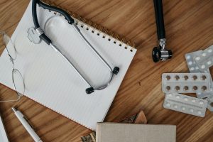 Flat lay of medical tools and supplies on a wooden desk surface. — Top Suggestions to Buy Weed Online