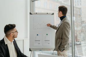 Two professionals examining graphs during an office presentation. — Understanding the Technology Behind IPTV Smarters Pro