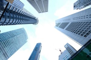 A striking upward view of various skyscrapers in an urban setting against a clear sky. — Unlocking the Benefits: Insights fro