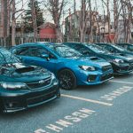 Multiple Subaru cars parked in an outdoor lot lined with trees, showcasing automotive design. — Used and new Automotive Barga