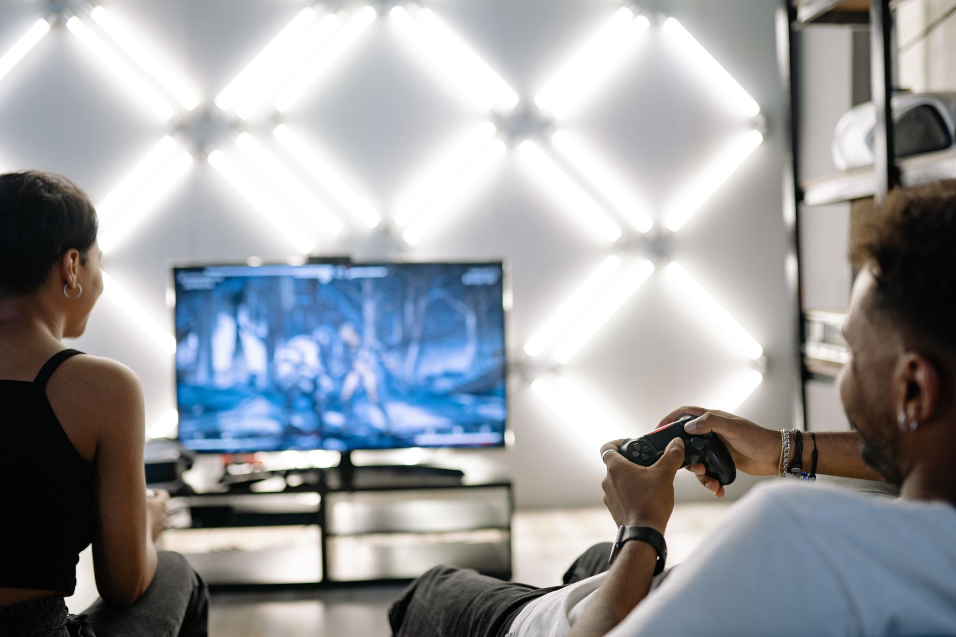 Two adults are having fun playing video games in a stylish, modern living room with LED lighting. — What are the top 5 tips f