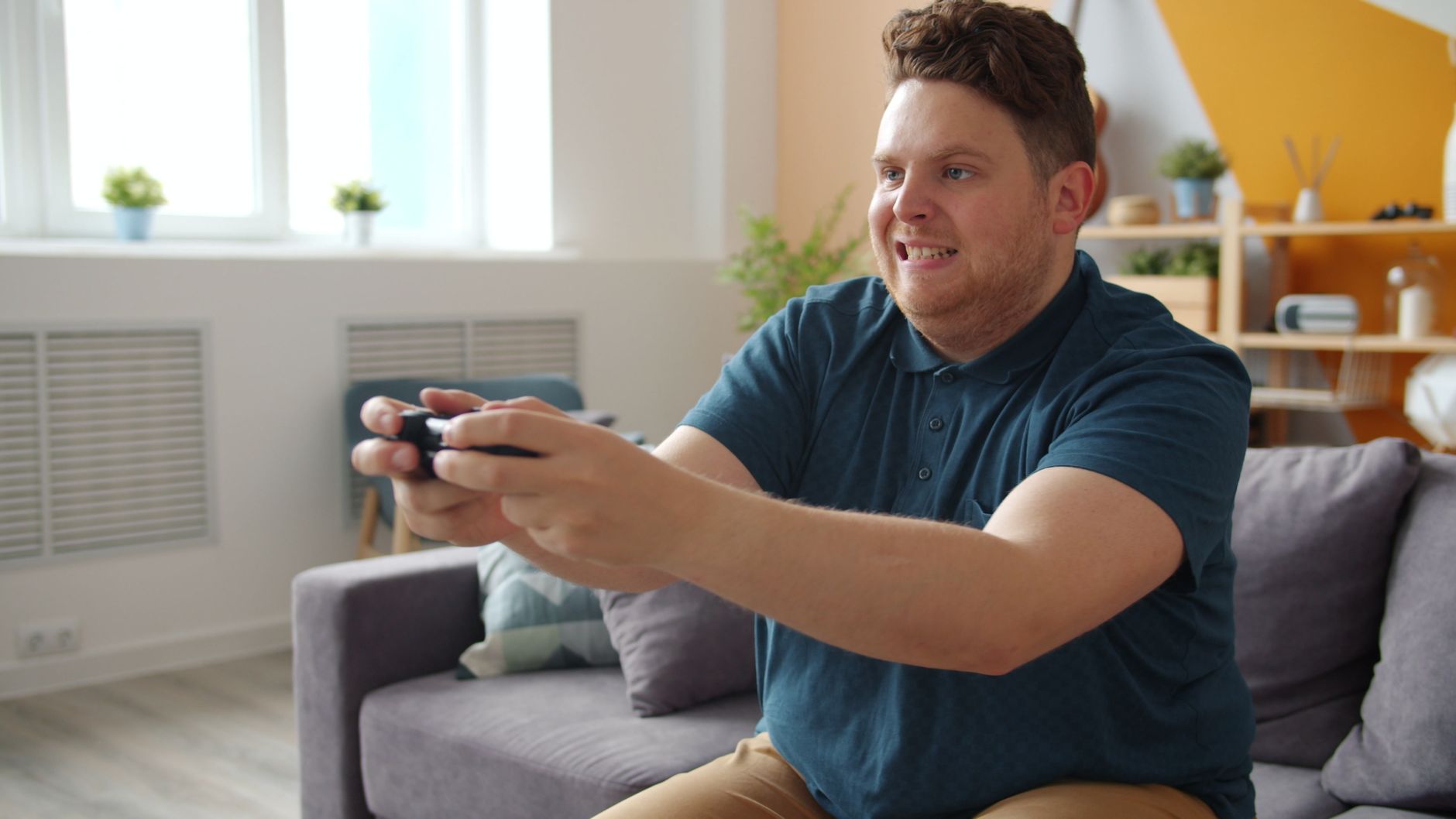 Man intensely focused on playing video games in a comfortable living room setting. — Why an Eat and Run Verification Site Hel