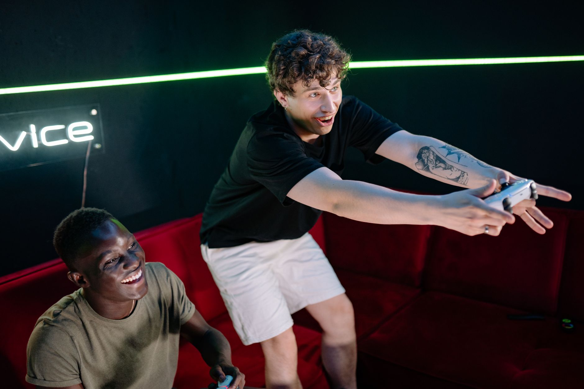 Two young men having fun playing video games in a cozy indoor setting. — Why Enjoying Baccarat With baccarat Is Better