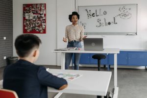 Educator leads interactive lesson in a classroom with a whiteboard display. — Why Learning Spanish Online Makes Language Lear